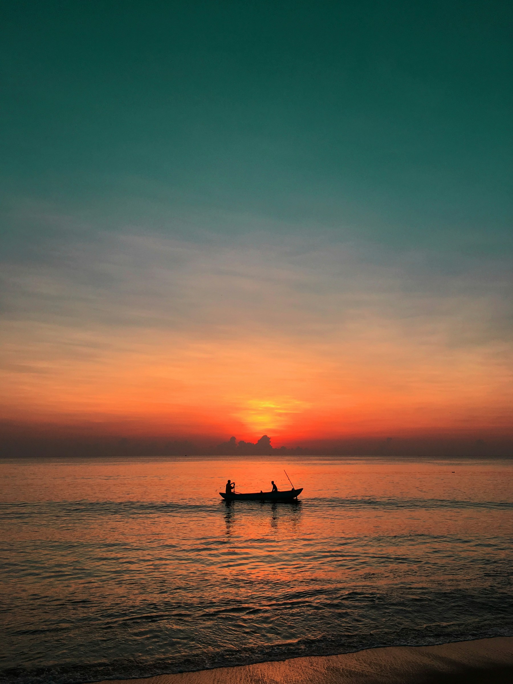 A fishing canoe silhouetted against the sunrise in Sri Lanka